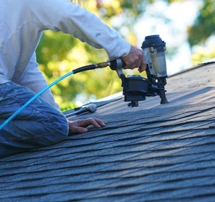 Person with nail gun on roof in Phoenix