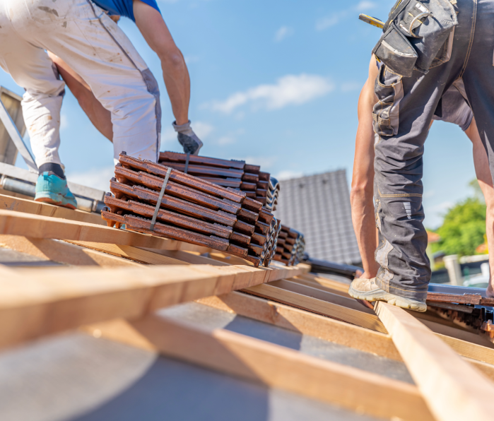 2 Men putting shingles on a roof in phoenix